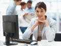 Pretty Caucasian business woman at office desk