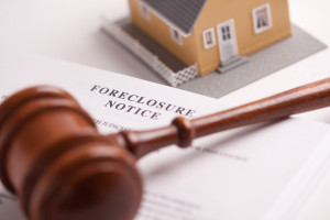 Foreclosure Notice, Gavel and Model Home with Selective Focus.